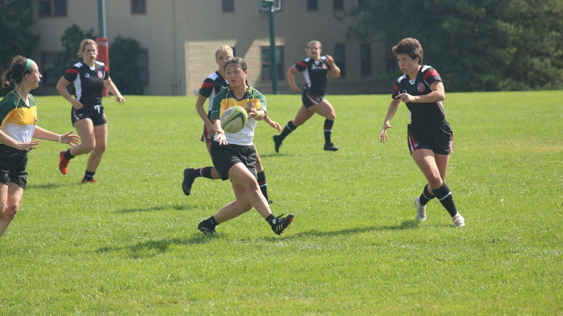 Kianna Hanson (center) initiates a pass to a teammate in a Rugby 10s matchup with SLU on Saturday. Thumbnail